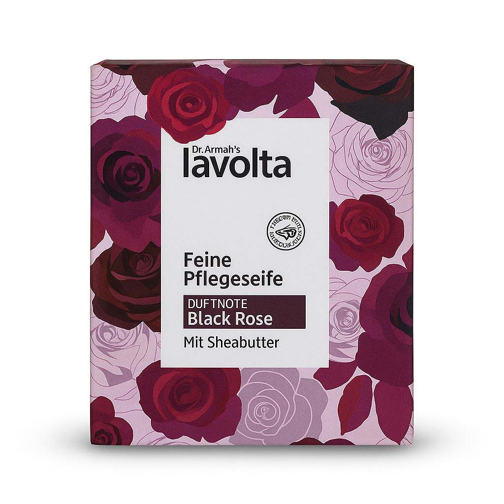 Eine Nahaufnahme der quadratischen Verpackung einer "Dr. Armah's lavolta Feine Pflegeseife". Die Schachtel ist mit einem dunklen, luxuriösen Rosenmuster verziert. Die zentrale weiße Fläche zeigt den Produktnamen und die Duftnote "Black Rose".